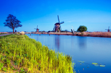 breathtaking beautiful inspirational landscape with windmills in Kinderdijk, Netherlands. Fascinating places, tourist attraction.