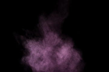 Purple powder explosion on black background. Colored powder cloud. Colorful dust explode. Paint Holi.