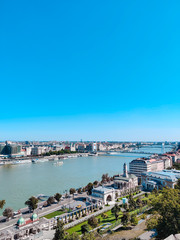 Fototapeta premium Amazing panorama of the city of Budapest on a sunny day. Bridge, river and small buildings. Vertical photo