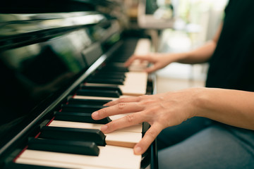 Scene of piano lessons online training or E-class learning while Coronavirus spread out or covid-19 crisis situation, vlog or teacher make online piano lesson to teach students pupils learn from home. © ztony1971