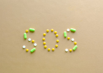 Inscription SOS of tablets on a light background. concept of disease