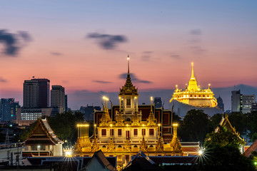 Golden Metal Castle at Wat Ratchanadda (Loha Prasat) and Gloden Mount at Wat Sraket Rajavaravihara at sunset in Bangkok Thailand. The both famous landmark temple and pagoda in Bangkok Thailand.
