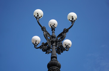 Fototapeta na wymiar Decorative lamp post Greek revival architectural style ornamental outdoor streetlight. 