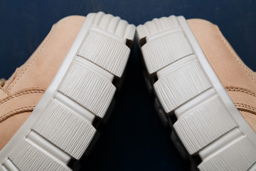 Brown women's leather shoes on a gray background. Fashion trend
