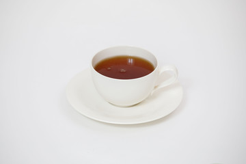 white cup with tea on a white background