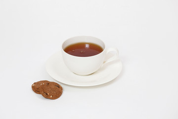 white cup with tea and cookies on a white background