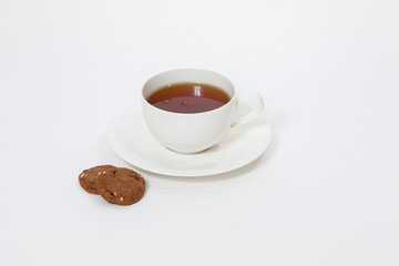 white cup with tea and cookies on a white background