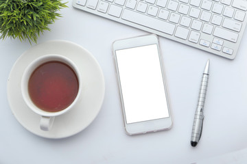 top view of smart phone with white screen on office desk 