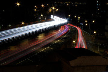 Fototapeta na wymiar Car Trails in New York City. White and Red Car Lights at night in Brooklyn seen from the Brooklyn Bridge