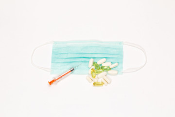 injection wand, pills and mask on a white background