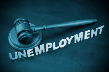 Unemployment and economics crisis concept, wooden judge gavel and word unemployment.
