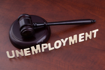 Unemployment and economics crisis concept, wooden judge gavel and word unemployment.
