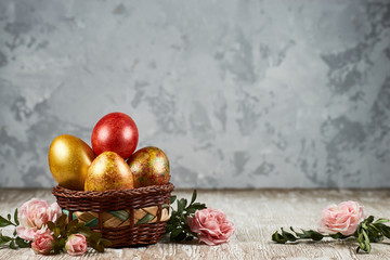 Easter eggs in basket on color wooden background