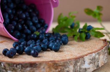 fresh ripe blueberries are scattered on a wooden table