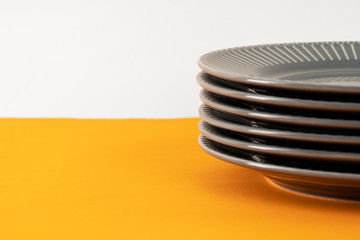 Glossy new ceramic dishware on paper background. Close up