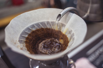 Barista preparing a v60 pour over filter. Specialty coffee cafe in Europe