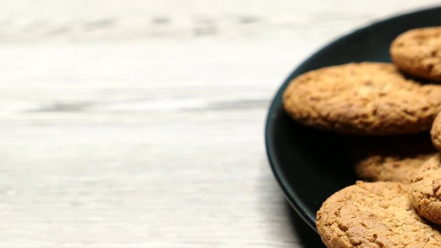 Fresh Brown Oatmeal Cookies On A Black Plate On A Gray Wooden Background Diagonal Slider Shot, Close-up..
