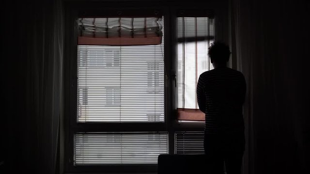 Silhouette Of A Man Slowly Opening The Window Curtains - Close Up Shot