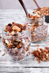 Homemade granola with different nuts and seeds in glass jars