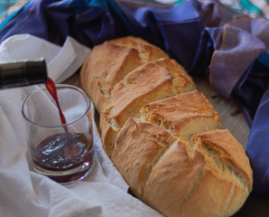 pouring red wine and homemade bread