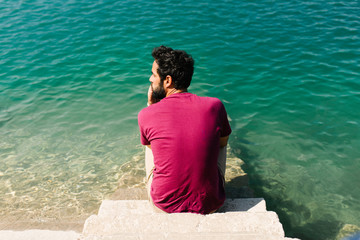 pensive man on the lakeshore