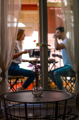 Paar sitzt am Balkon und trinkt Kaffee