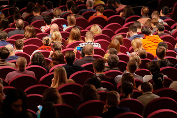 Business conference attendees sit and listen