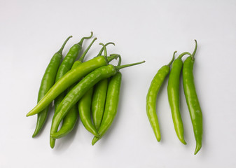 Bunch of green chili peppers isolated on white