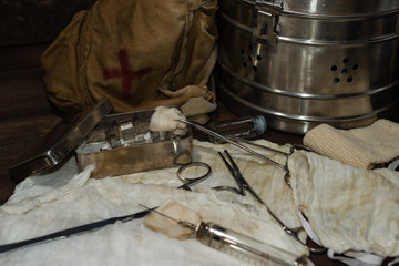 Surgical instrument of an old military doctor on a wooden table. Military medicine