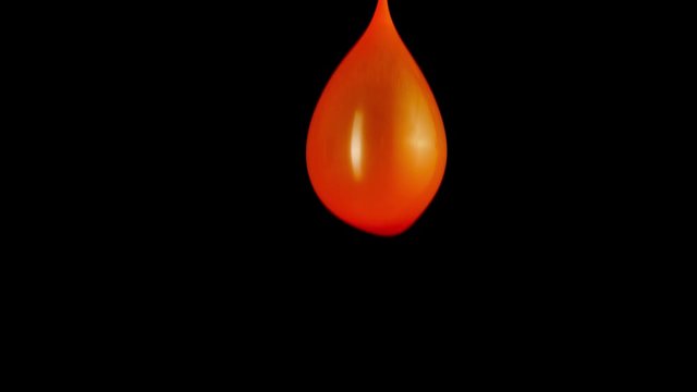 Slow motion water balloon sways up and down. Close up. - Powered by Adobe