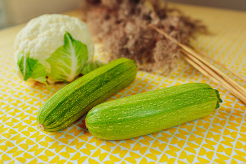 Healthy nutrition, healthy food on the table, greens and vegetables, cauliflower, cucumbers and squash.