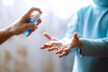 Hands with sanitizer antiseptic. Mother and child using sanitize antiseptic for hand coronavirus protection.Hygiene concept. Prevent spread of germs and bacteria and avoid infections coronavirus.