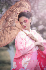 Beuatiful girl wearing japanese traditional kimono in orchard during spring - 333741215