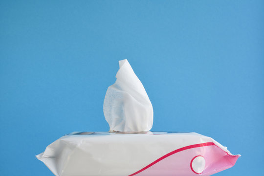 Hand Sanitizer On Blue Background, Disposable Wet Wipes With An Antiseptic To Prevent Coronavirus Infection And Personal Hygiene