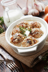 Meatballs with rice in a creamy sauce