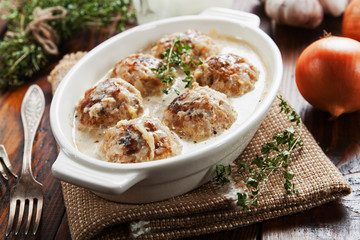 Meatballs with rice in a creamy sauce