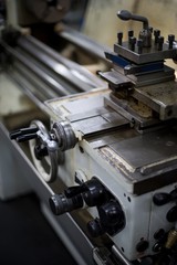 Abandoned machine metalworking lathe in a factory closing due to the pandemic virus