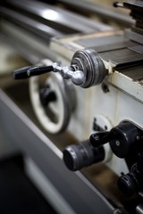 Abandoned machine metalworking lathe in a factory closing due to the pandemic virus