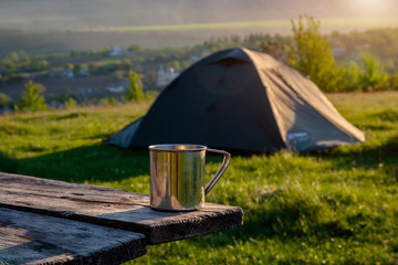 Tourist tent on green grass at sunrise. © Sergii