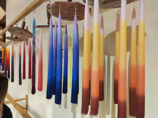 Handmade candles hanged on wax rope after manufacturing