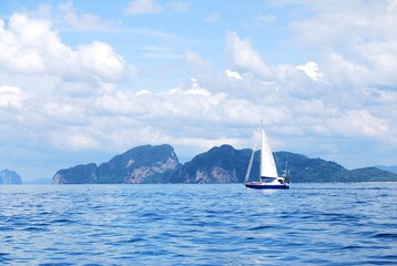 A white sailboat sailing at Krabi sea of Thailand.