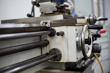 Abandoned machine metalworking lathe in a factory closing due to the pandemic virus