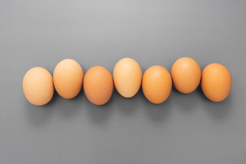 Raw eggs isolated on grey background, protein food.