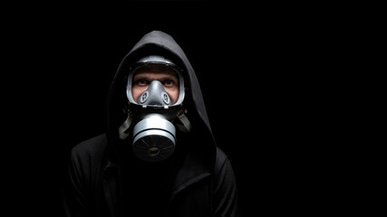 Sad man wearing gas mask as protection against deadly coronavirus infection. Concept health virus coronavirus epidemic. Copy space.