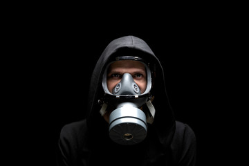 Man in a gas mask and a hood. Gas protect medical antibacterial antiviral spray paint mask. Concept health virus coronavirus epidemic.