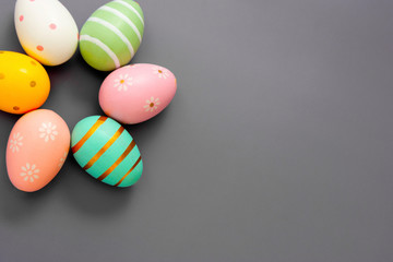 Easter decorative colorful eggs. Grey background, top view, copy space.