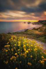 Beautiful sunset at Petra tou Romiou - Aphrodite's Rock, the birthplace of Aphrodite and a popular...