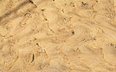 Sand under water, view from above