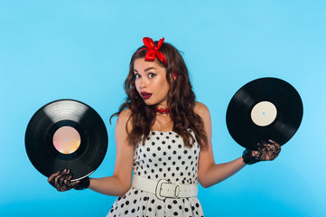 Beautiful girl singer holds music records in her hands