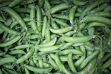 Green peas in a heap for sale at farmers market